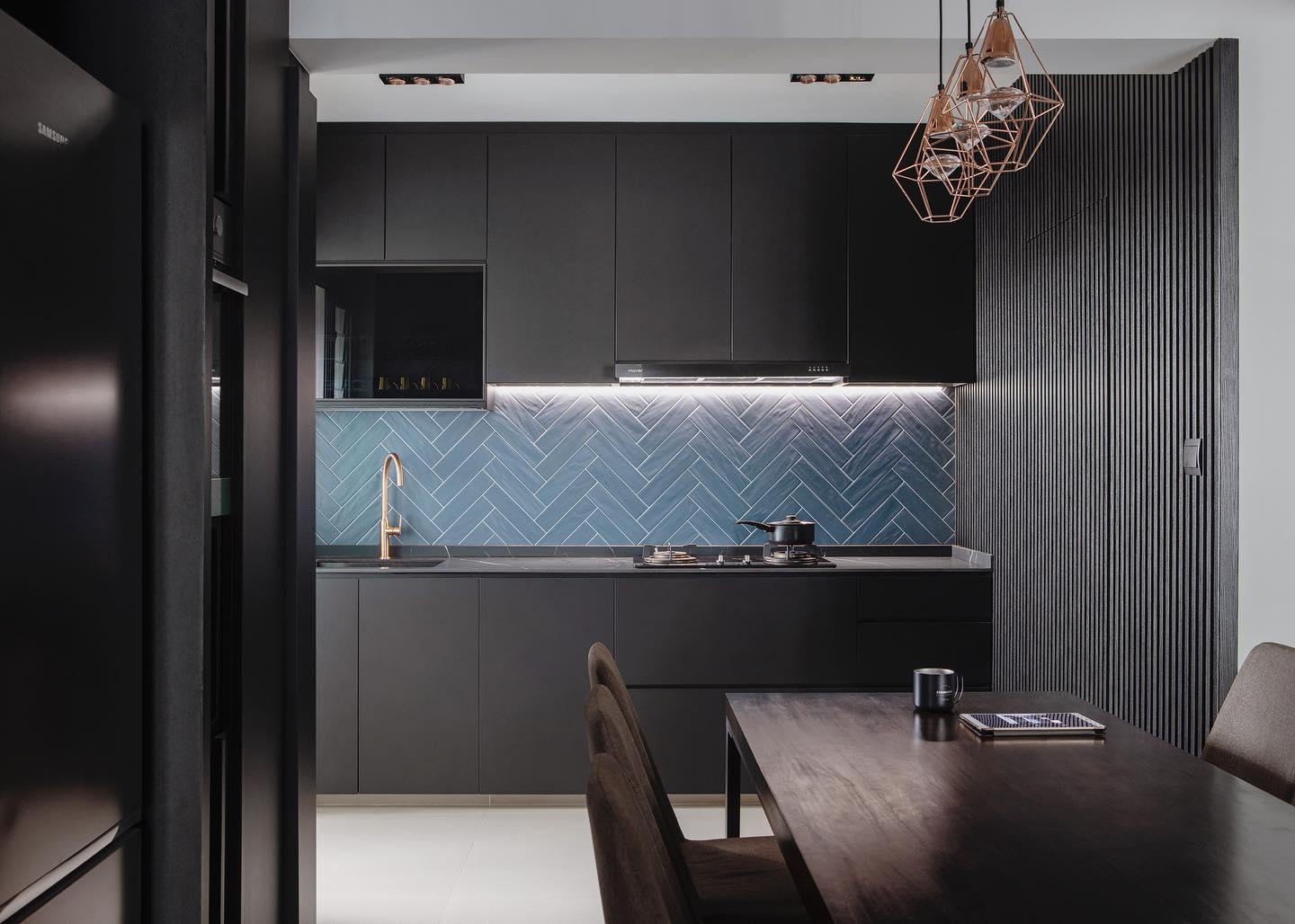 Dark kitchen and dining with blue herringbone backsplash